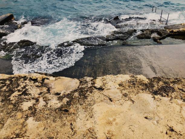 istock Splashing Waves Over Rocky Sea 1054844316
