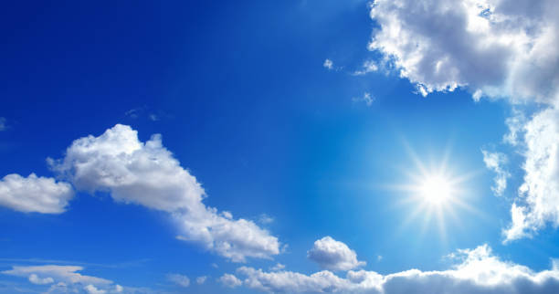 istock conceptual background image of blue sky with clouds and shining sun 1054848540