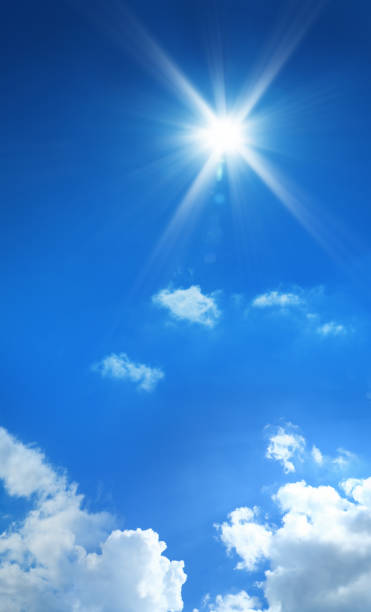 istock conceptual background image of blue sky with clouds and shining sun 1054849520