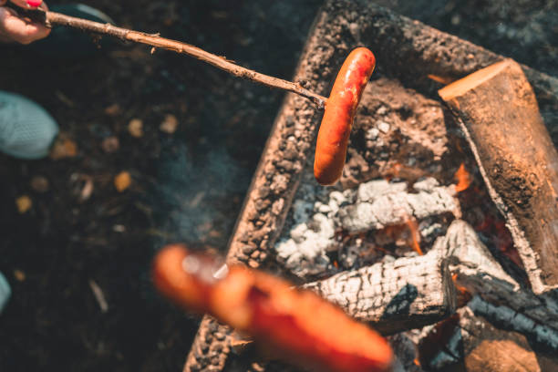Senior women grilling sausage in Sweden
