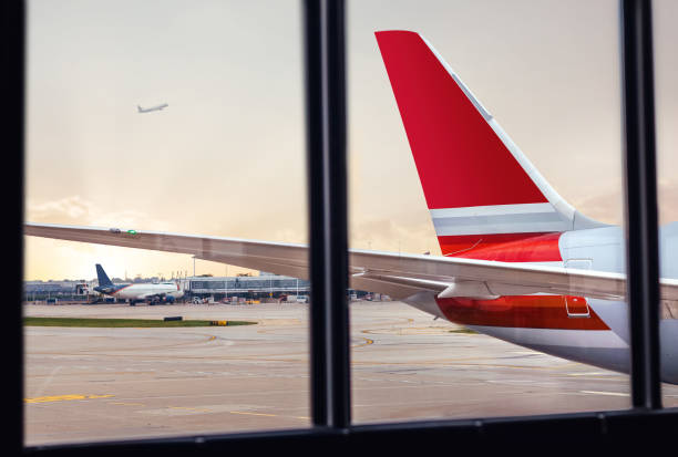 istock View of airplane fuselage tail through window at airport 1054855534