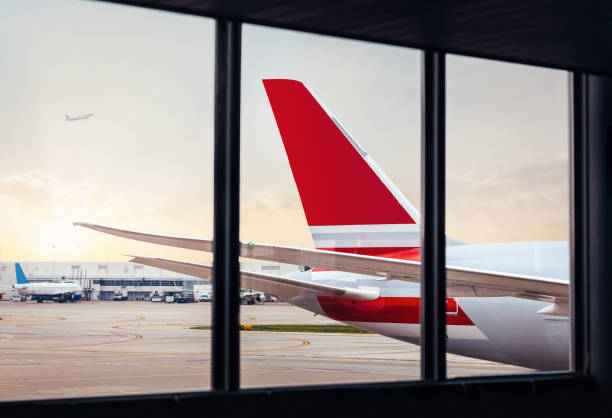 istock View of airplane fuselage tail through window at airport 1054855544