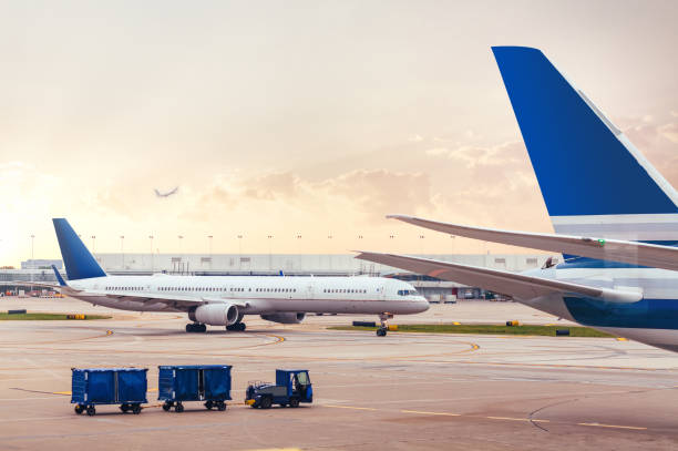 istock Two airplanes on tarmac with cargo at airport 1054855574