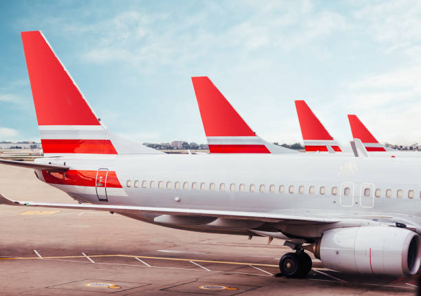 Row of plane fuselage tails on tarmac at airport Row of plane fuselage tails on tarmac at airport convoy stock pictures, royalty-free photos & images