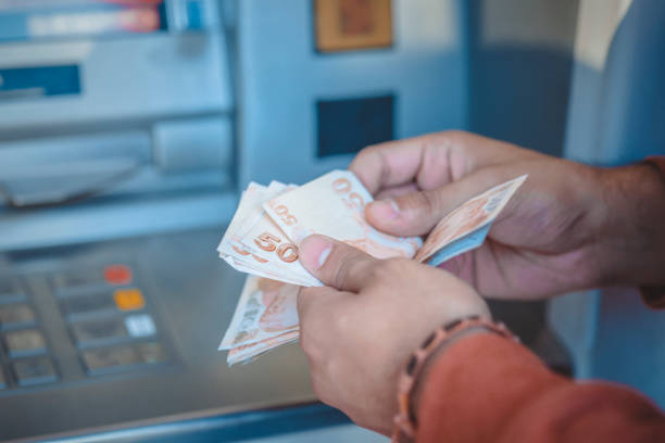 Cash dispenser and Money Cash dispenser and Money turkish lira photos stock pictures, royalty-free photos & images