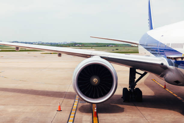 istock View of airplane wing and engine on tarmac at airport 1054855672