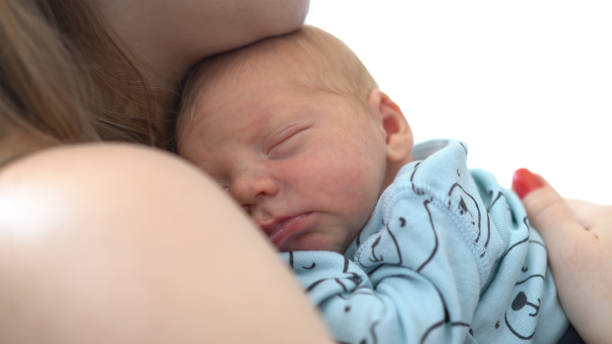 istock Mother Care of Sleeping newborn 1054855682