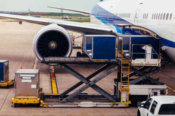 istock View of airplane wing and engine on tarmac with cargo 1054855686