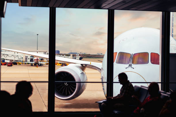 istock View of airplane front through airport lounge window 1054855746
