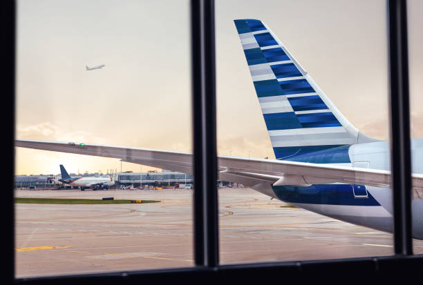 istock View of airplane fuselage tail through window at airport 1054862374