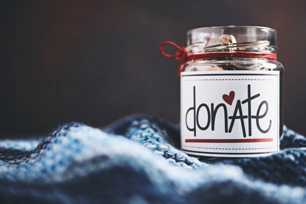 istock Donation money jar filled with coins 1054863976