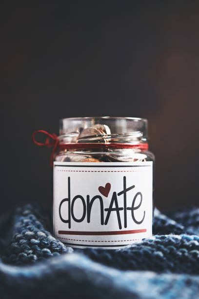 istock Donation money jar filled with coins 1054863996