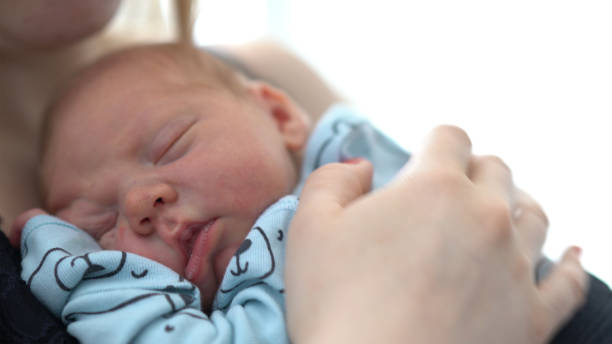 istock Mother Care of Sleeping newborn 1054864444