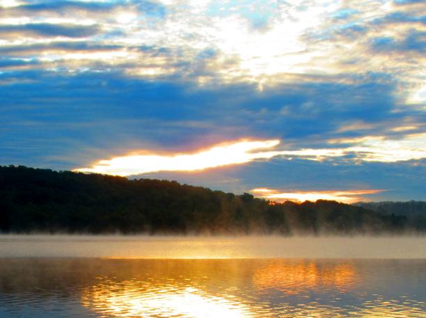 istock sun coming up on a foggy morning 1054866264