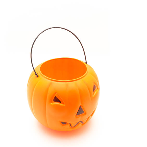 istock Funny face on plastic Halloween pumpkin pail isolated on white 1054868252