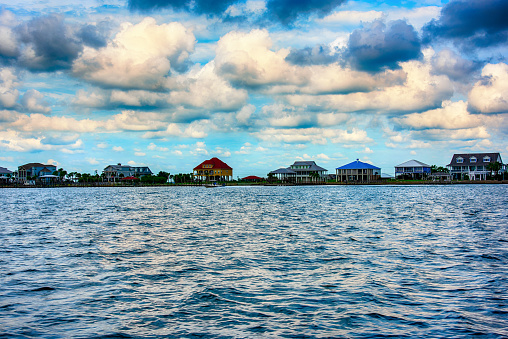 A group of residential buildings on stilts along the shores of Lake Pontchartrain in Slidell Louisiana, near New Orleans.