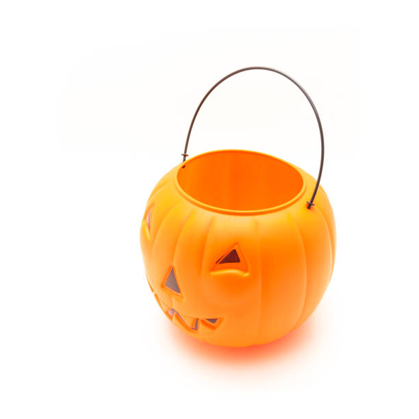 istock Funny face on plastic Halloween pumpkin pail isolated on white 1054868272