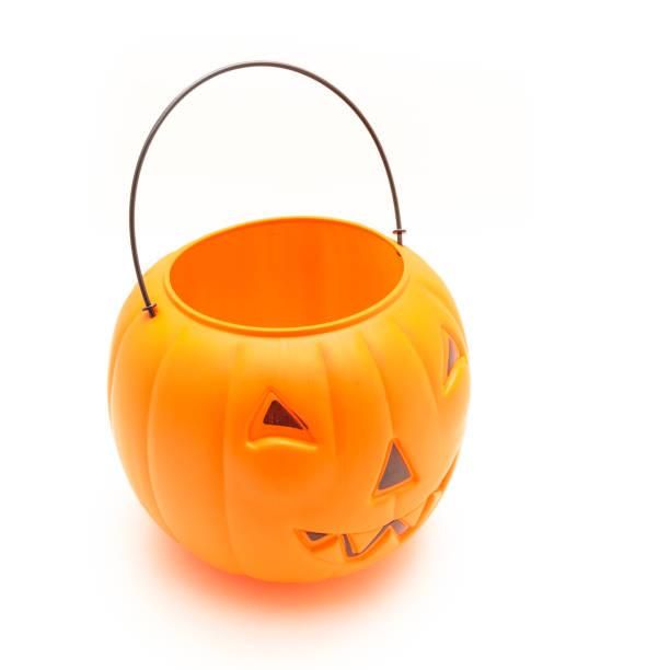 istock Funny face on plastic Halloween pumpkin pail isolated on white 1054868274