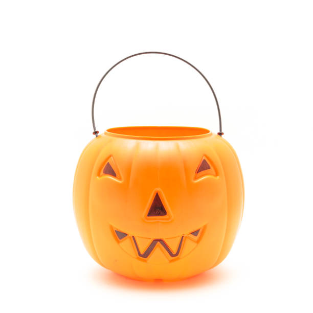 istock Funny face on plastic Halloween pumpkin pail isolated on white 1054868278