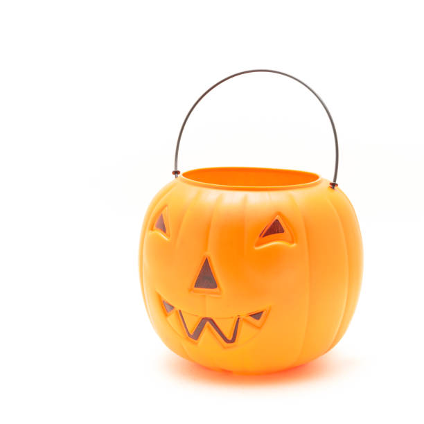 istock Funny face on plastic Halloween pumpkin pail isolated on white 1054868286