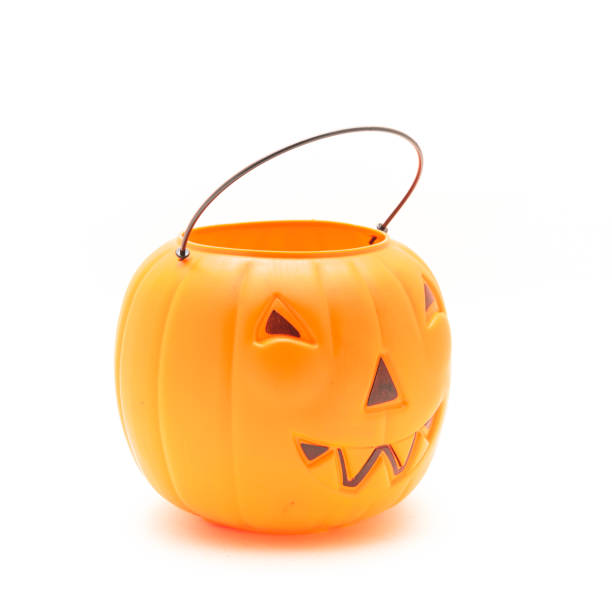 istock Funny face on plastic Halloween pumpkin pail isolated on white 1054868292