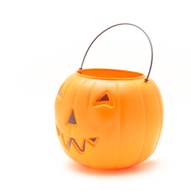 istock Funny face on plastic Halloween pumpkin pail isolated on white 1054868294