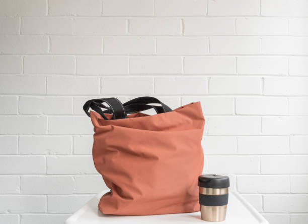 istock Reusable coffee cup and shopping tote bag on table 1054868348
