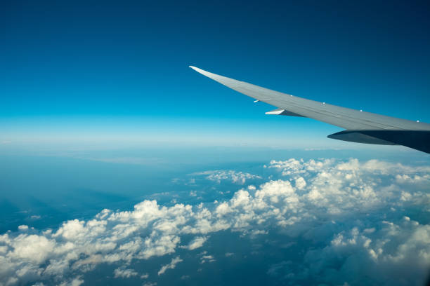 istock Aircraft flying above the clound and blue sky. 1054870790