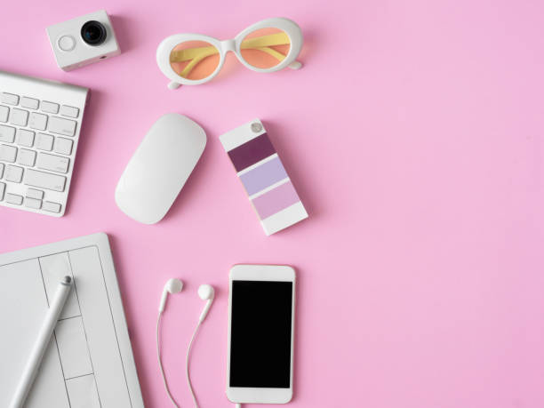 istock top view of office desk workspace with smartphone, notebook, graphic tablet, keyboard and mouse on pink color background, graphic designer, Creative Designer concept. 1054871442