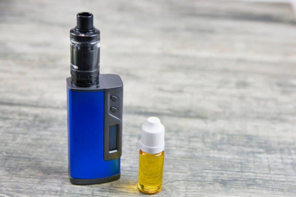 istock E - cigarette for vaping , technical devices.The liquid in the bottle 1054879402