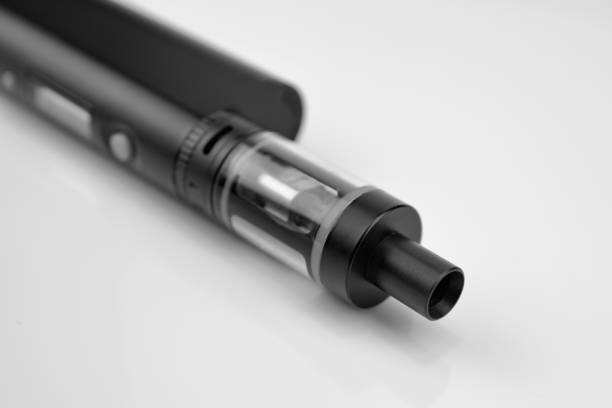istock E - cigarette for vaping , technical devices.The liquid in the bottle 1054879508