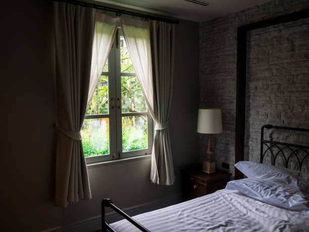 istock window old viallage garden view in the dark room. 1054884866
