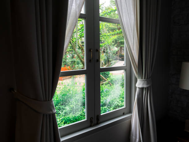 istock window old viallage garden view in the dark room. 1054884930