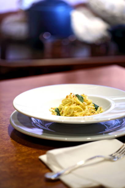 macaroni on guitar as butter and sage pasta on the guitar with butter and sage cooked selective focus vertical pasta stock pictures, royalty-free photos & images