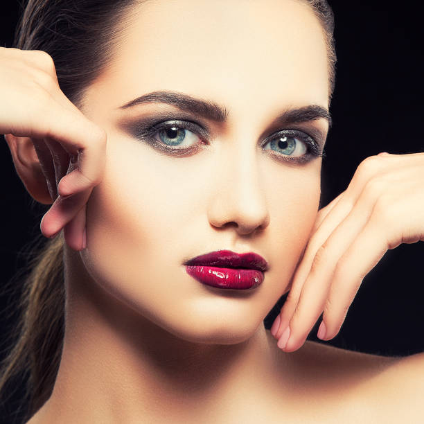 istock Beautiful model girl close-up face with bright make-up 1054892498