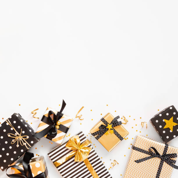 istock Top view of gift boxes in various black, white and golden designs. Flat lay, copy space. A concept of Christmas, New Year, birthday celebration event. 1054894406