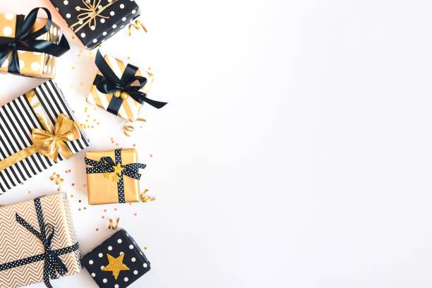 istock Top view of gift boxes in various black, white and golden designs. Flat lay, copy space. A concept of Christmas, New Year, birthday celebration event. 1054894418