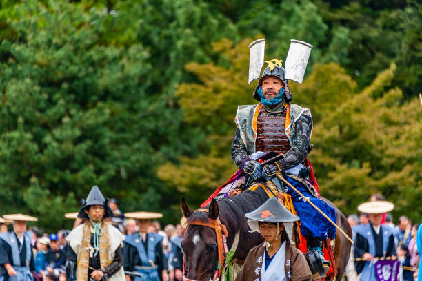 Kyoto, Japan - October 22, 2012:  Samurai warrior on horse at the Jidai Matsuri festival. Also called the Festival of Ages it is a traditional festival celebrated every 22 of October since 1895 to commemorate the  anniversary of the foundation of Kyoto. It is a large parade with over two thousand people dressed in accurate costumes of the japanese history that spans 1100 years when Kyoto was Japan capital and also represents well important historic figures of the past. The parade goes from the Imperial Palace to the Heian Shrine.