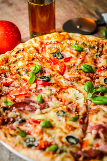 istock Appetizing Italian pizza on a wooden table 1054899290