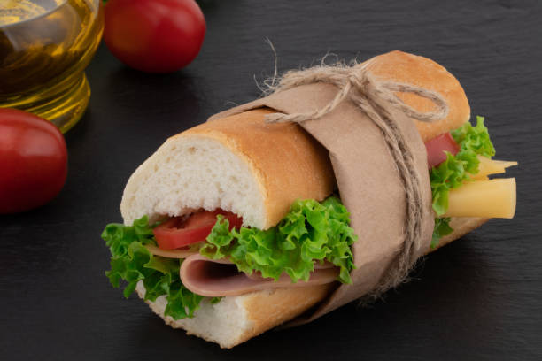 istock sandwich with with ham, cheese, tomatoes, lettuce on over stone 1054901924