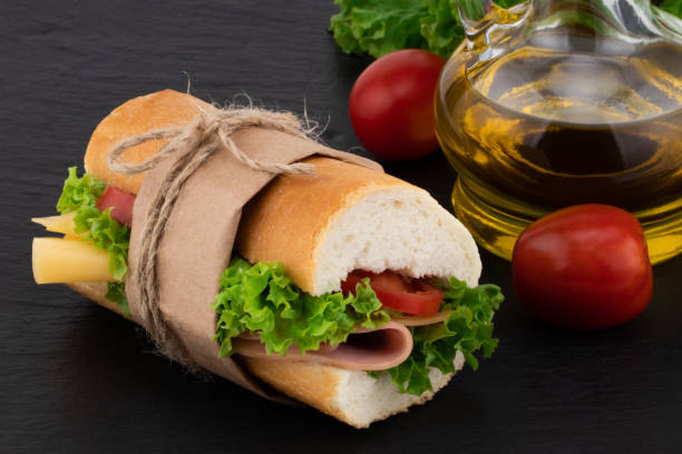 istock sandwich with with ham, cheese, tomatoes, lettuce on over stone 1054901954