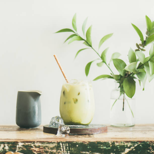 istock Iced matcha latte with milk pouring from pitcher, square crop 1054906434