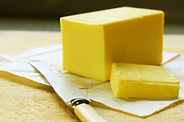 istock A cube of butter sliced with a knife  105490751