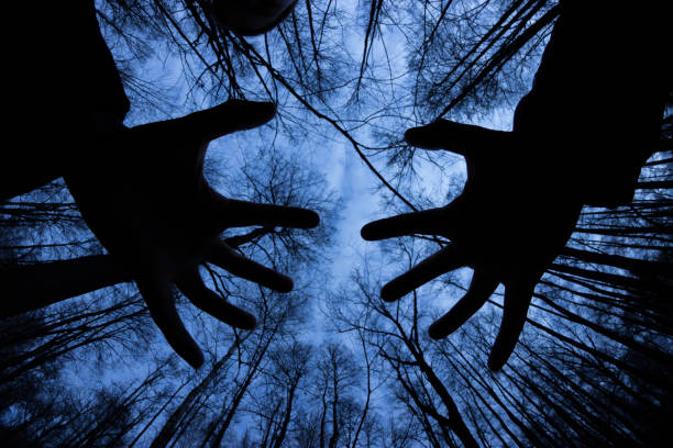 ghostly silhouette in spooky dark forest. halloween concept
