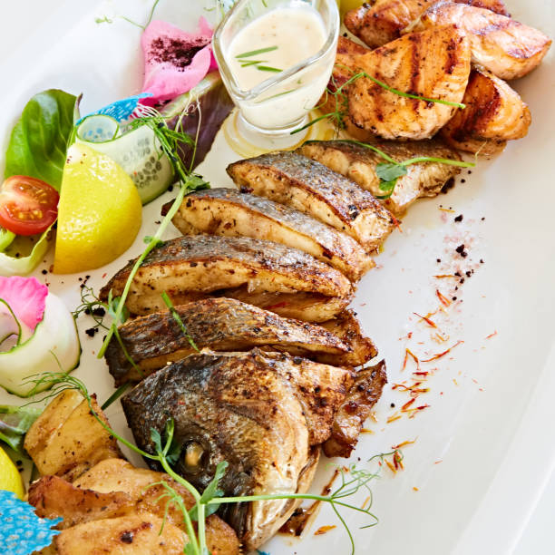 istock The fried fish on plate with vegetables. Shallow dof. 1054907776