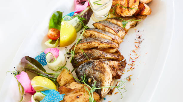 istock The fried fish on plate with vegetables. Shallow dof. 1054907808