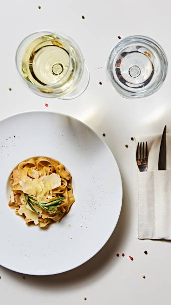 istock Close-up italian pasta plate with grated parmesan cheese and basil leaf 1054907856