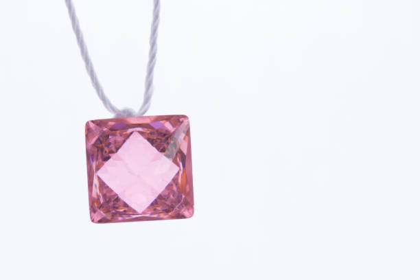 colorful glass pendants on light background.