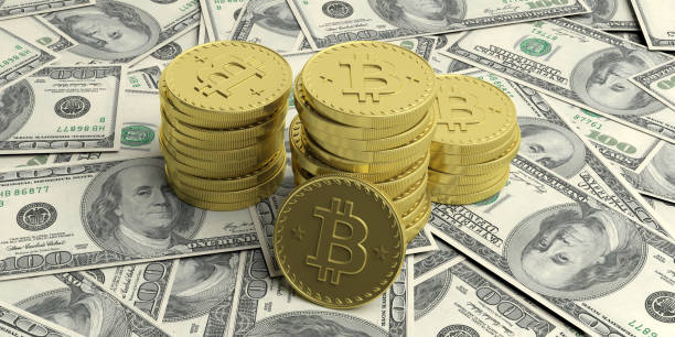 istock Cryptocurrency concept. Bitcoins on 100 dollars banknotes background, banner. 3d illustration 1054910826