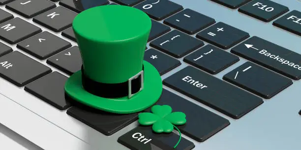 Photo of St Patricks Day hat with four leaf clover on computer keyboard. 3d illustration